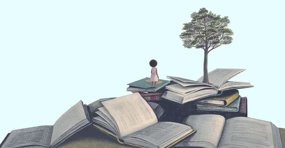 A mountain made of books. There is a tree at the top.