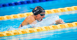 Frau schwimmt eine Bahn.