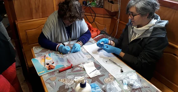 Microbiologists from the University of Mexico City process samples aboard a ship.