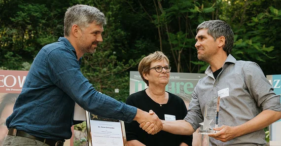 Preisträger erhält einen Preis, zwei, die ihn übergeben