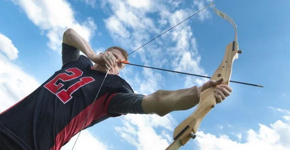 Sportler der einen Bogen schießt.