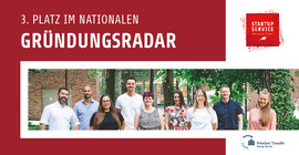 Several people stand together as a group.